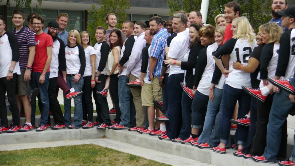 HireVue Team shows off converse shoes at company meeting