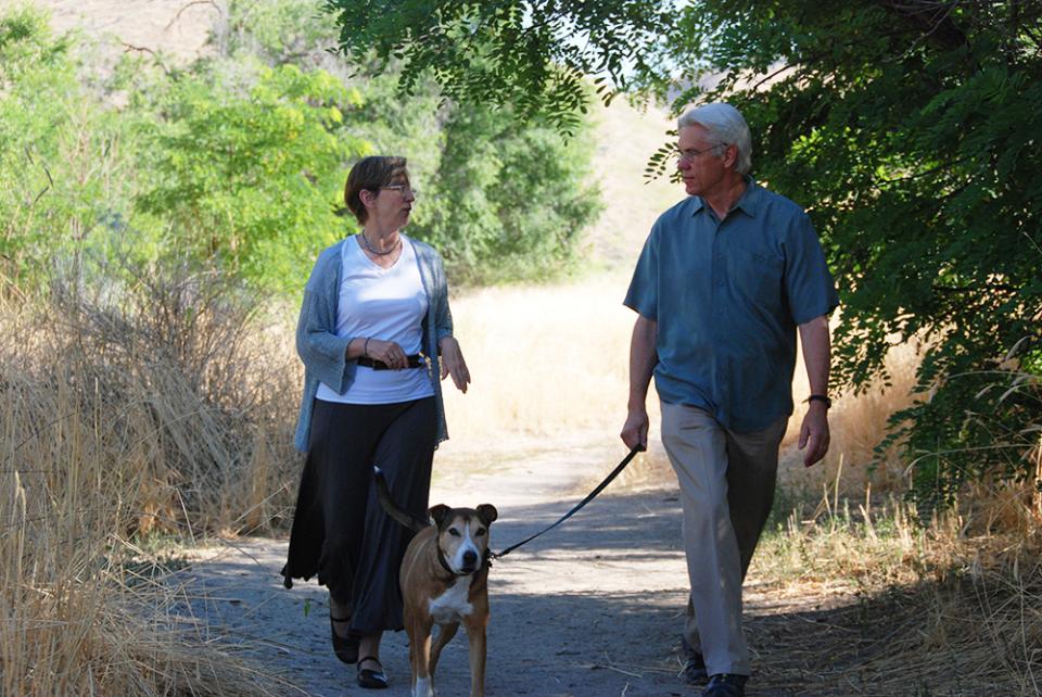 Don Kemper, founder and former CEO, and his wife Molly, former senior vice president of mission, walk their dog Tuva on the Healthwise Boise campus.