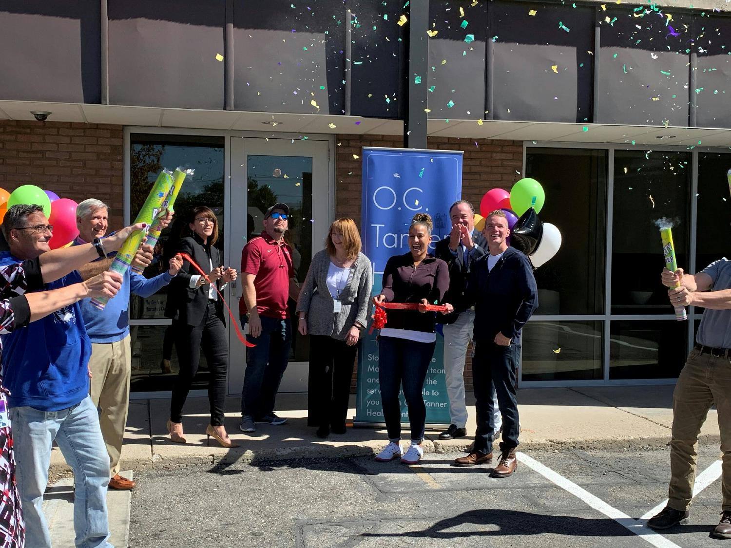 Employees celebrate the ribbon cutting of the onsite O.C. Tanner Health Center