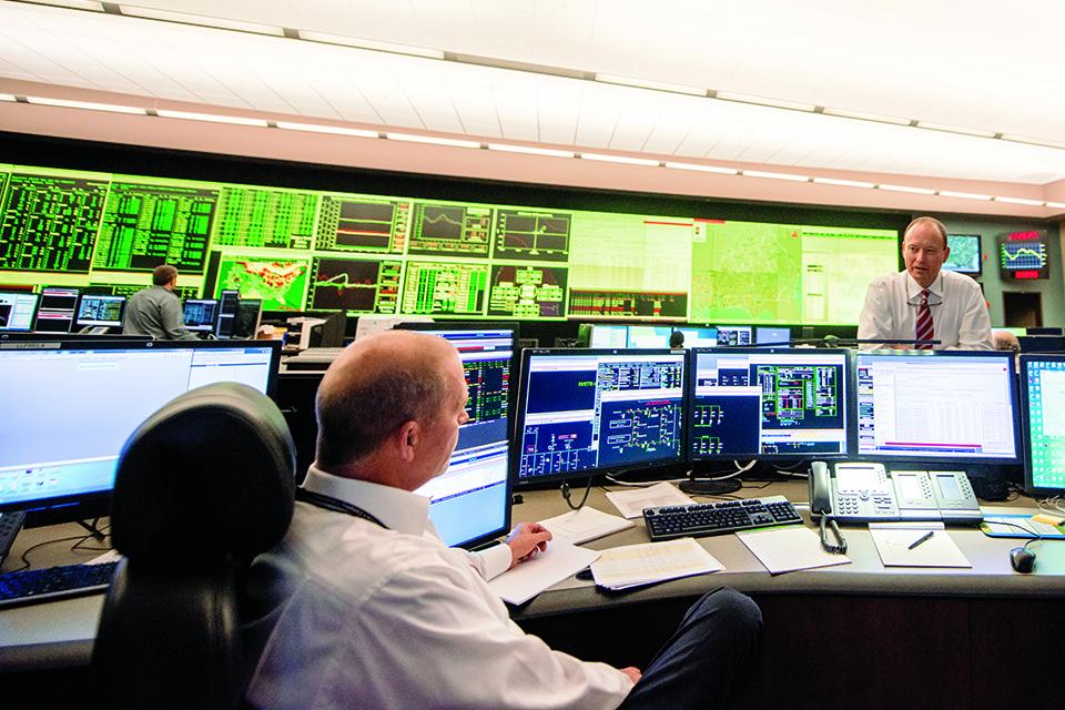 Todd Lucas, general manager of bulk power operations, confers with system operator Greg Lee at Southern Company's Power Coordination Center in Alabama.