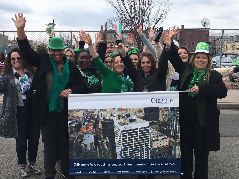 Employees gather to take a photo to celebrate the firm’s recognition as a great place to work by various organizations.