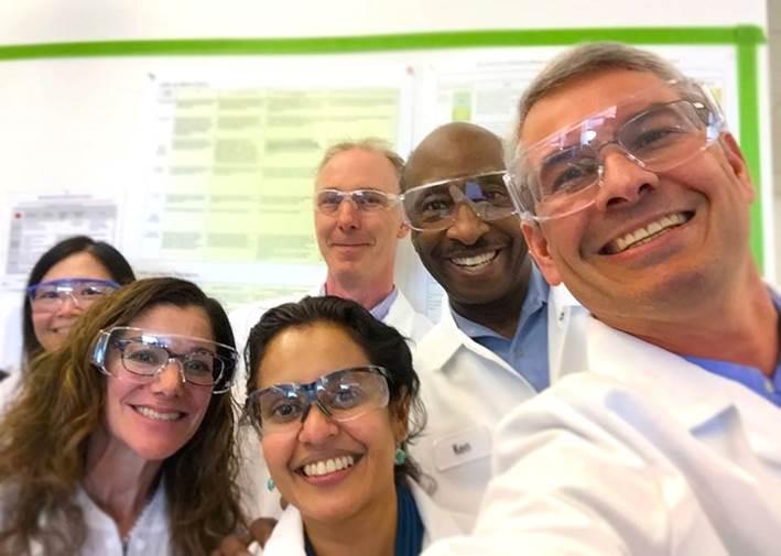 Merck CEO & President at manufacturing site meeting with colleagues