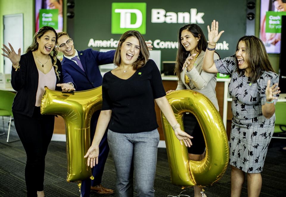 Colleague welcoming customers outside of a TD store in Florida. 