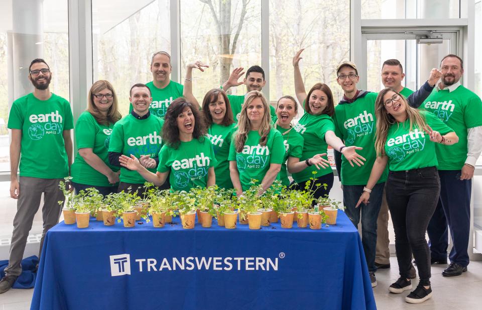 Asset Services team members celebrate Earth Day.