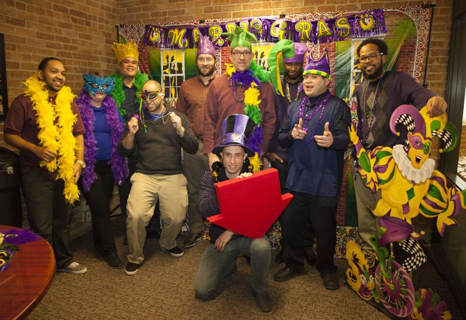 Employees having a good time at our Mardi Gras party.