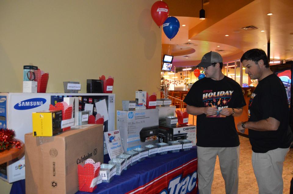 Team members eye raffle prizes at the annual Holiday Bowl event.