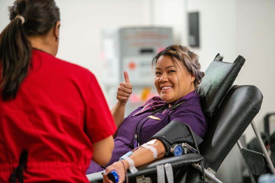 A Delta flight attendant donates blood at one of the company's many American Red Cross blood drives.