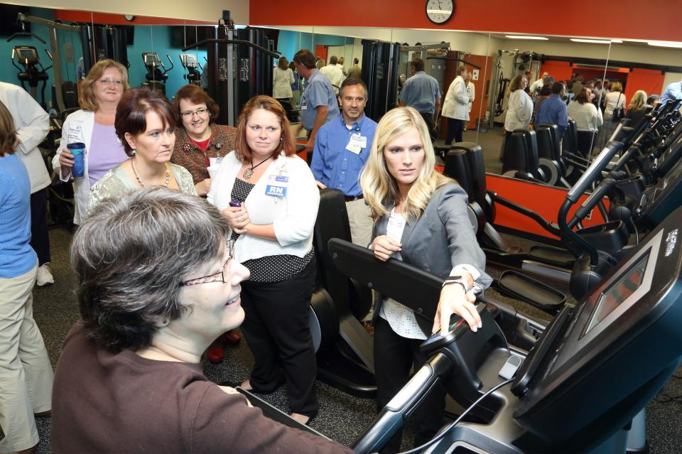 Employees check out the equipment at the opening of one of our Momentum Fit Studios, our onsite employee fitness studios.
