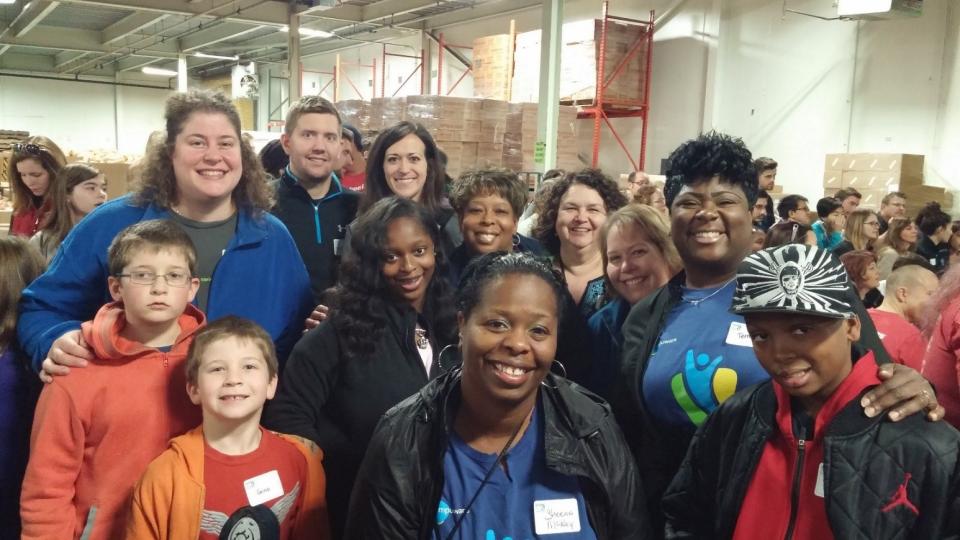 Compuware employees and family members stocking shelves at the local Gleaners Food Bank