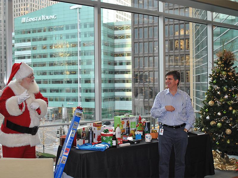 CEO Chris O'Malley jokes with Santa during our employee holiday party gift raffle