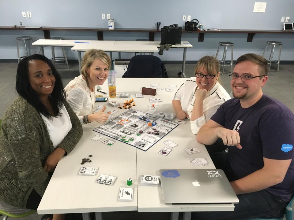 Employees playing the Appirio Customer Cycle Board Game