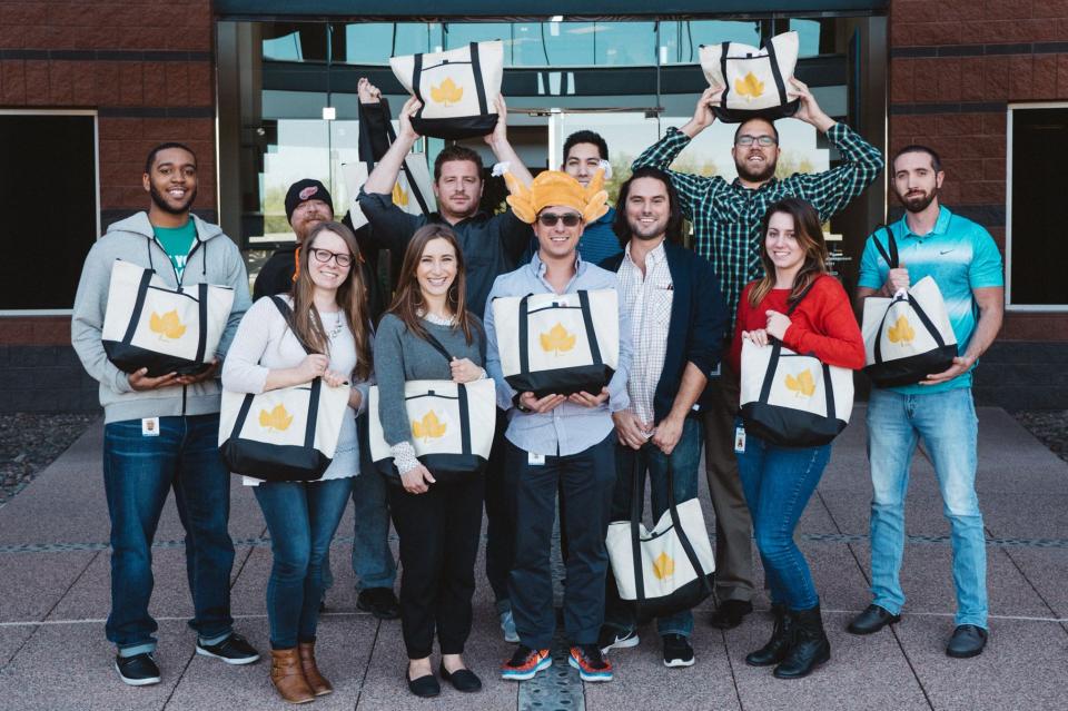 Nextiva team members showing off their yearly Thanksgiving turkeys!