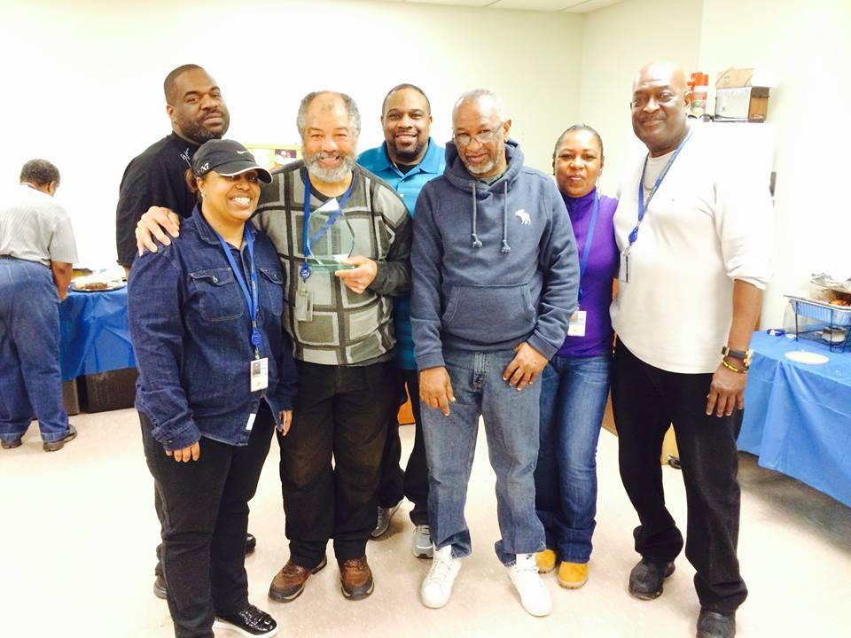 Employees at an annual Jamaican potluck lunch for the building!