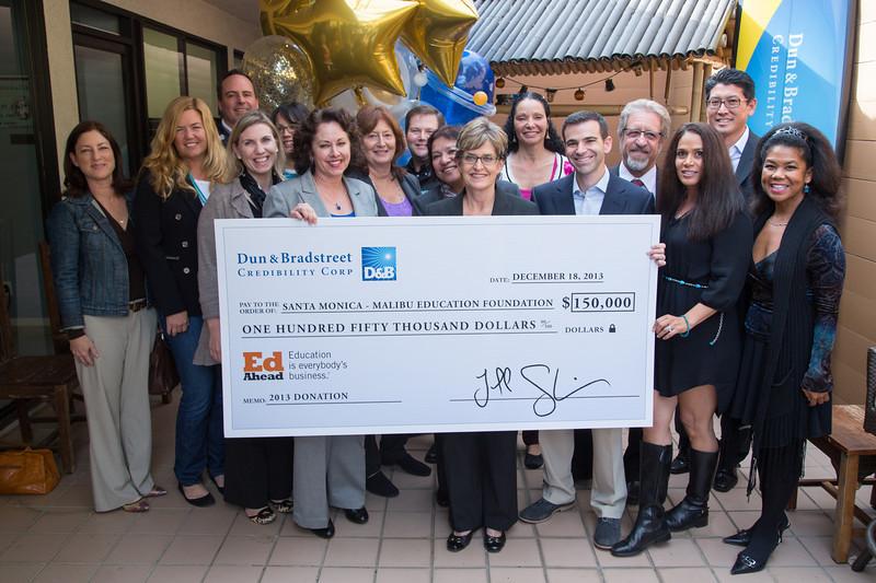 Dun & Bradstreet Credibility Corp.'s CEO, Jeff Stibel, presents a $150,000 check from the company's EdAhead program to the Malibu Education Foundation at the company's back patio/bbq area during the celebratory lunch.