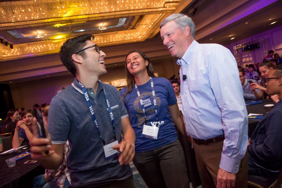 Visa CEO Alfred F. Kelly laughing with summer interns at Visa's 2018 Global Intern Summit