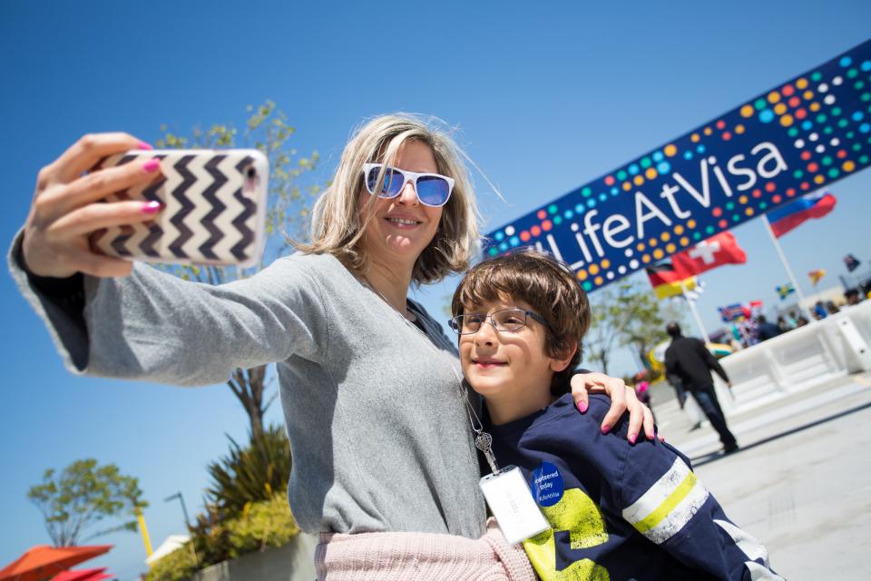 A Visa employee and her son pose for a photo during Visa's 2018 Bring Your Child to Work Day celebration