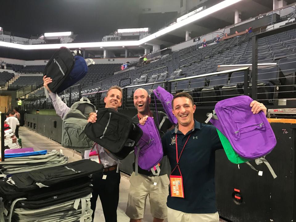 Members of our sales team pack backpacks for back to school