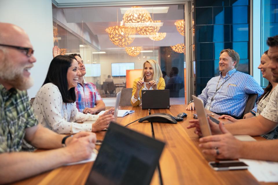 Vivint Smart Home employees enjoying each others' company during a meeting at Vivint's headquarters.