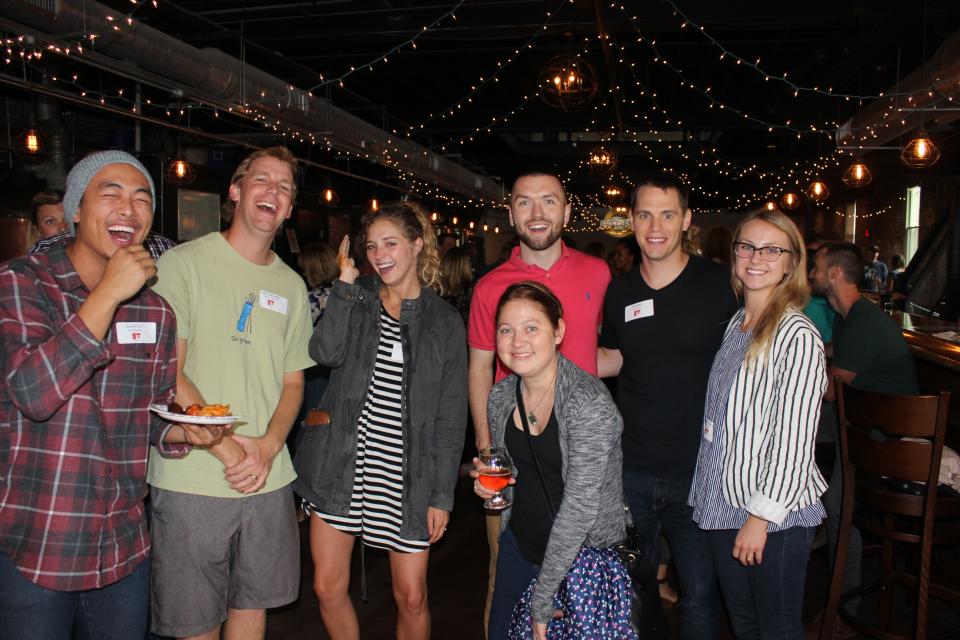 Team members gather for some fun at our monthly after-hours social