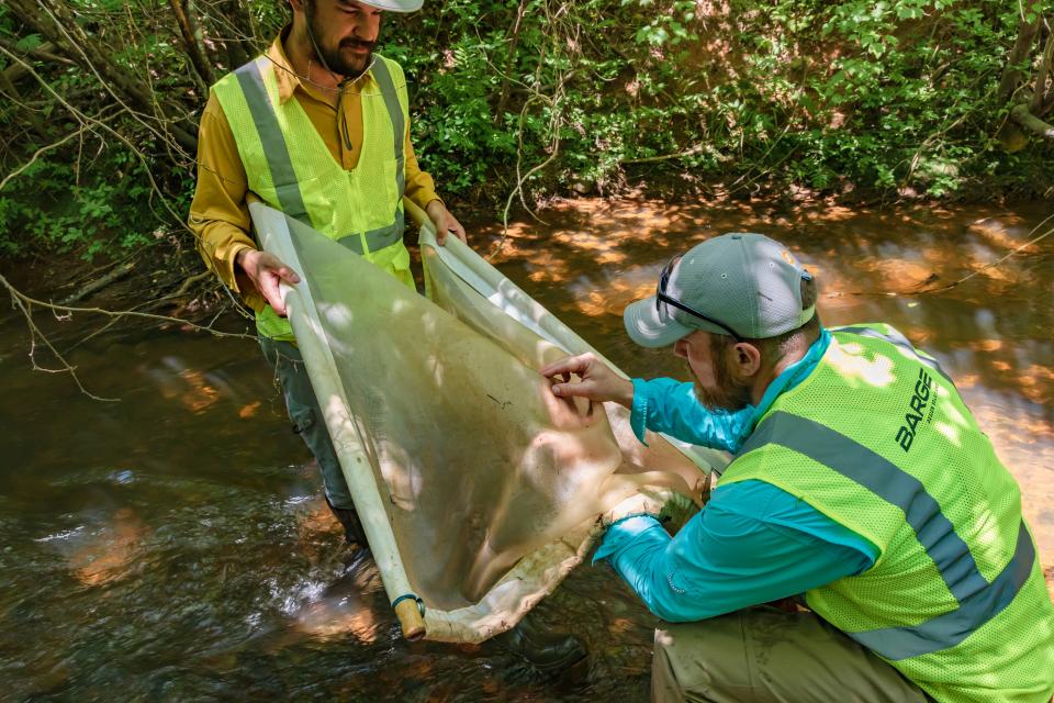 Employees volunteer their time to clean up local streams.