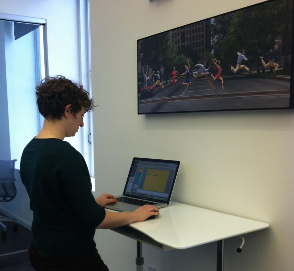 Senior Graphic Designer working at a standing desk