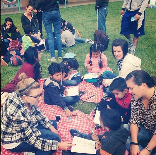 Employees reading with their mentees as part of our foundation's mentor program