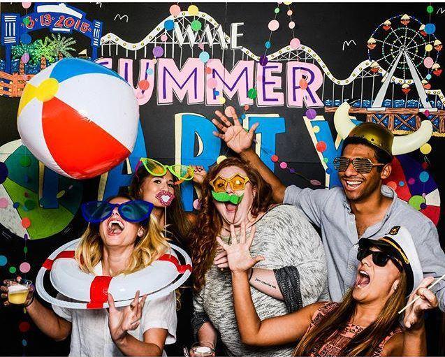 Employees enjoying the photo booth at our annual Summer Party.