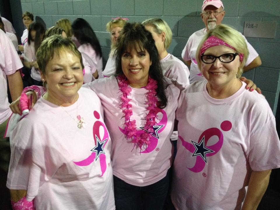 Haynes and Boone staff participating in a special Cowboys half-time celebration to promote breast cancer awareness.