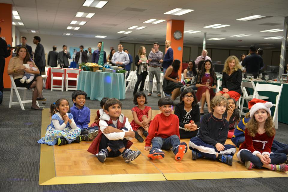 Kids of employees watch a live puppet show at the Holiday Party.