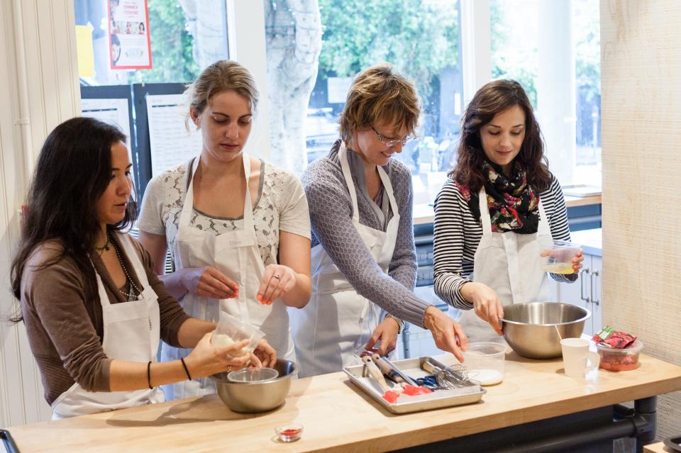 C1 team members participate in a cooking class making yummy macaroons