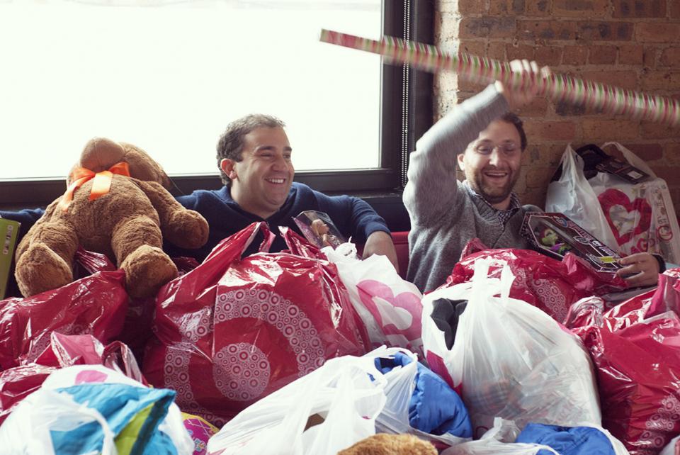 SingleHop co-founders buried in a sea of holiday gifts after SingleHop-sponsored shopping spree for Chicago-area charities.