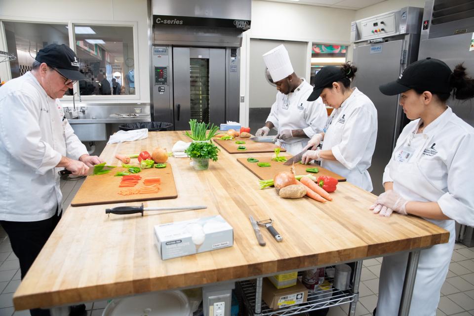 St. Jude Executive Chef Rick Farmer demonstrates chopping techniques as part of the new St. Jude 5-Star Culinary Academy designed to help staff members enhance their culinary skills and knowledge.