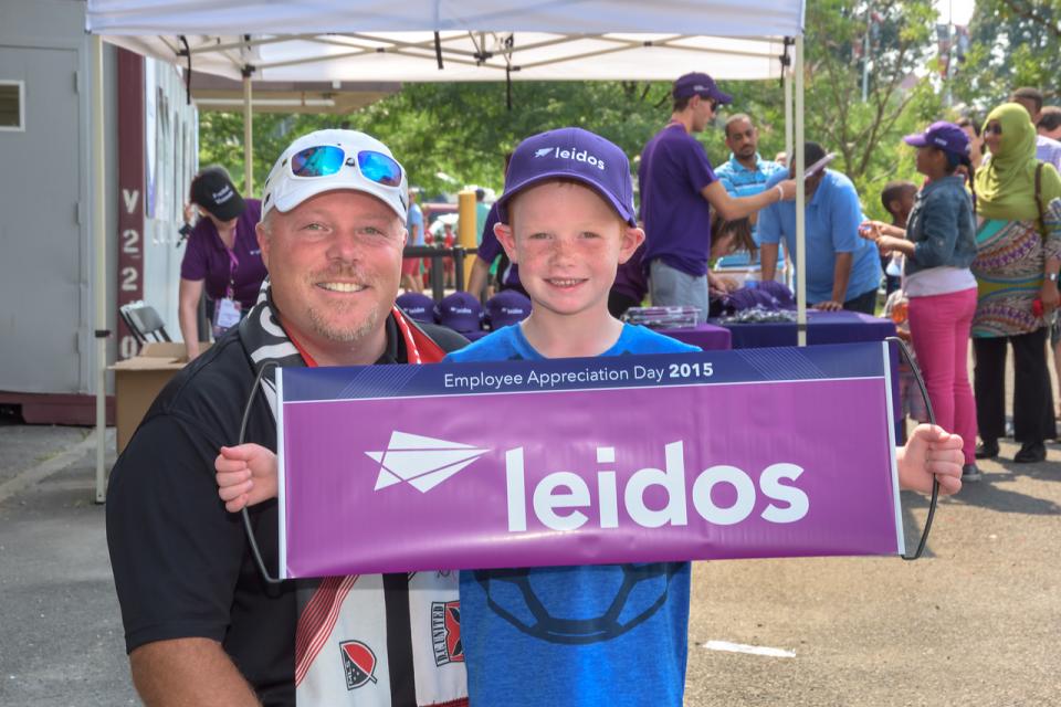 Leidos employee with his son attending a DC United game for employee appreciation day on July 26, 2015 at RFK Stadium in Washington DC.