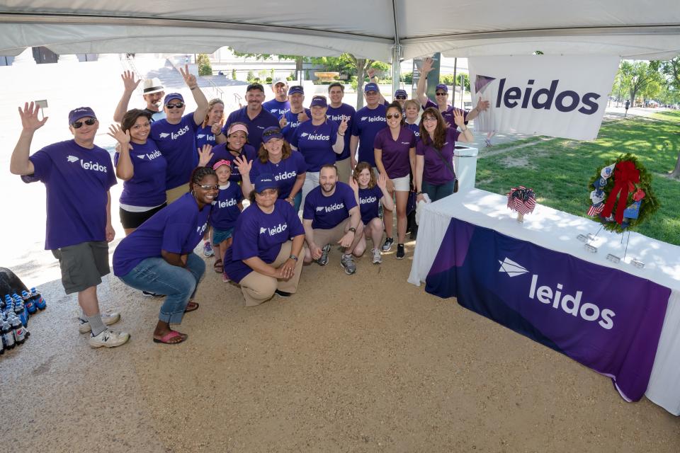 Volunteers gathered inside a tent during the 2015 Memorial Day parade in Washington DC, which was partially sponsored by Leidos.