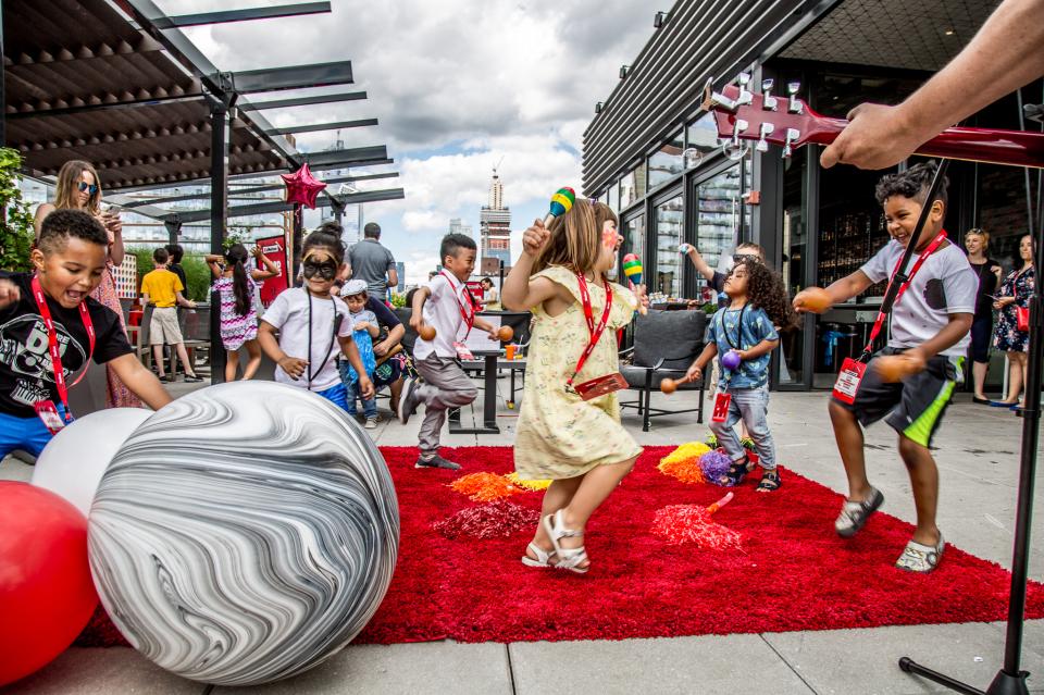 Children dance and groove during a rooftop concert at Live Nation during Kid Nation, the company’s take on Bring your Child to Work Day.