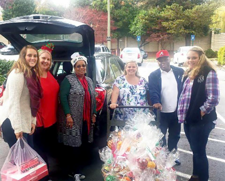 In Atlanta, Hunton employees and their children take part each year in a holiday event during which they assemble fruit baskets for residents of local nursing facilities. These volunteers were all smiles as they delivered more than 75 baskets last December!