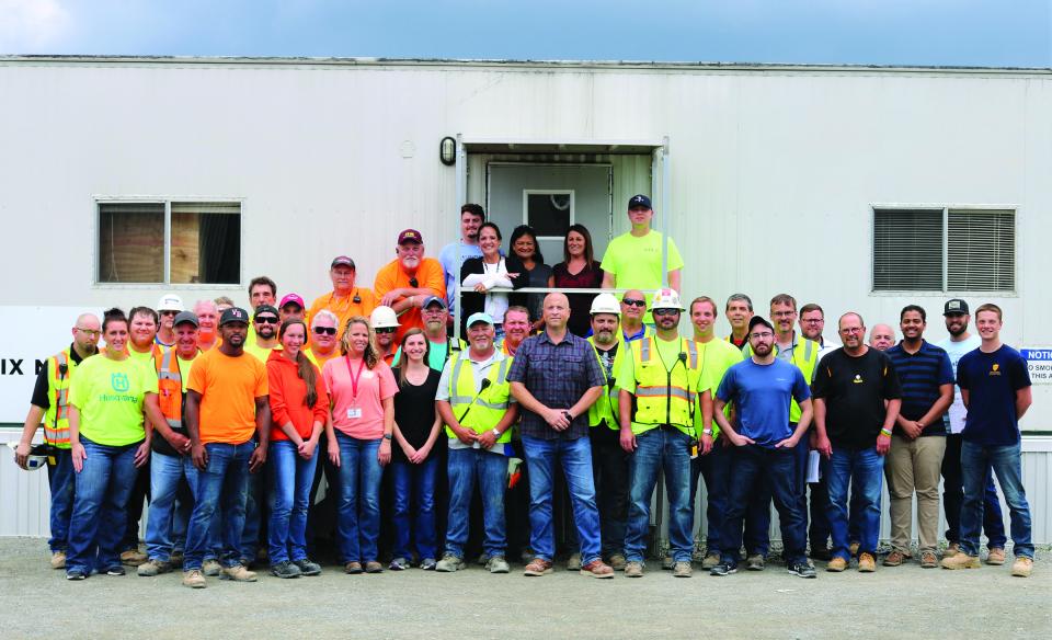 Fabrication shop employees posing for a group picture. 