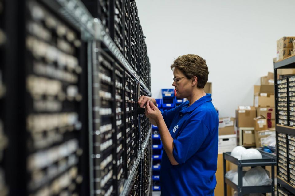 Inventory Staff stock parts for electronic repairs.