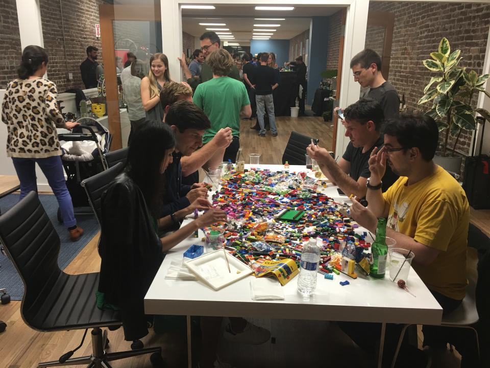 Front employees working together to answer questions during a trivia night 