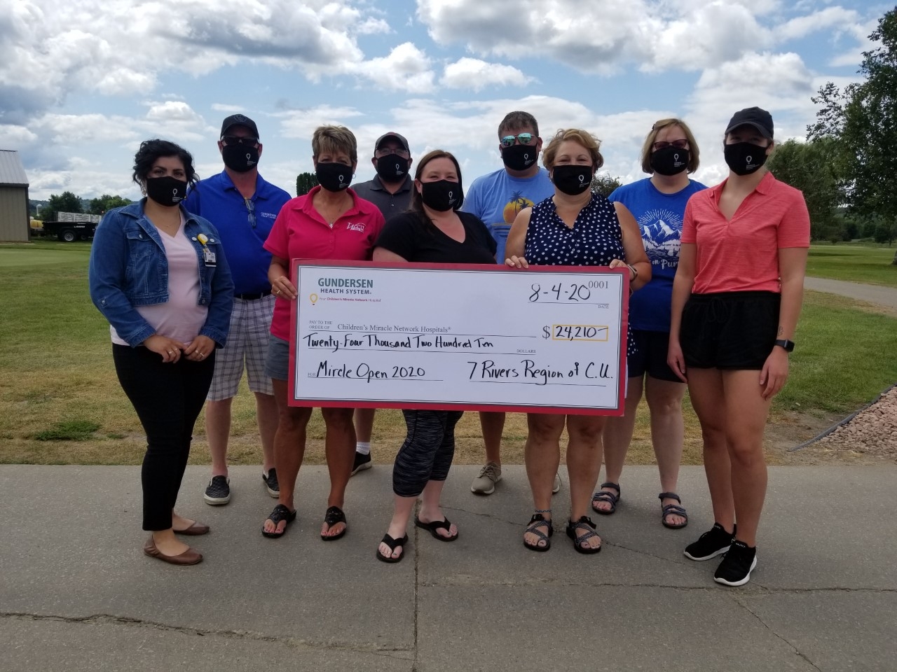 Representatives from area Credit Unions present a check to Gundersen Health System from the Miracle Open Golf Classic.