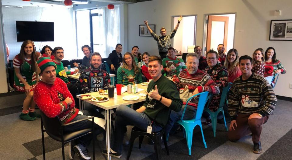 The Atom team enjoying lunch with holiday sweaters.