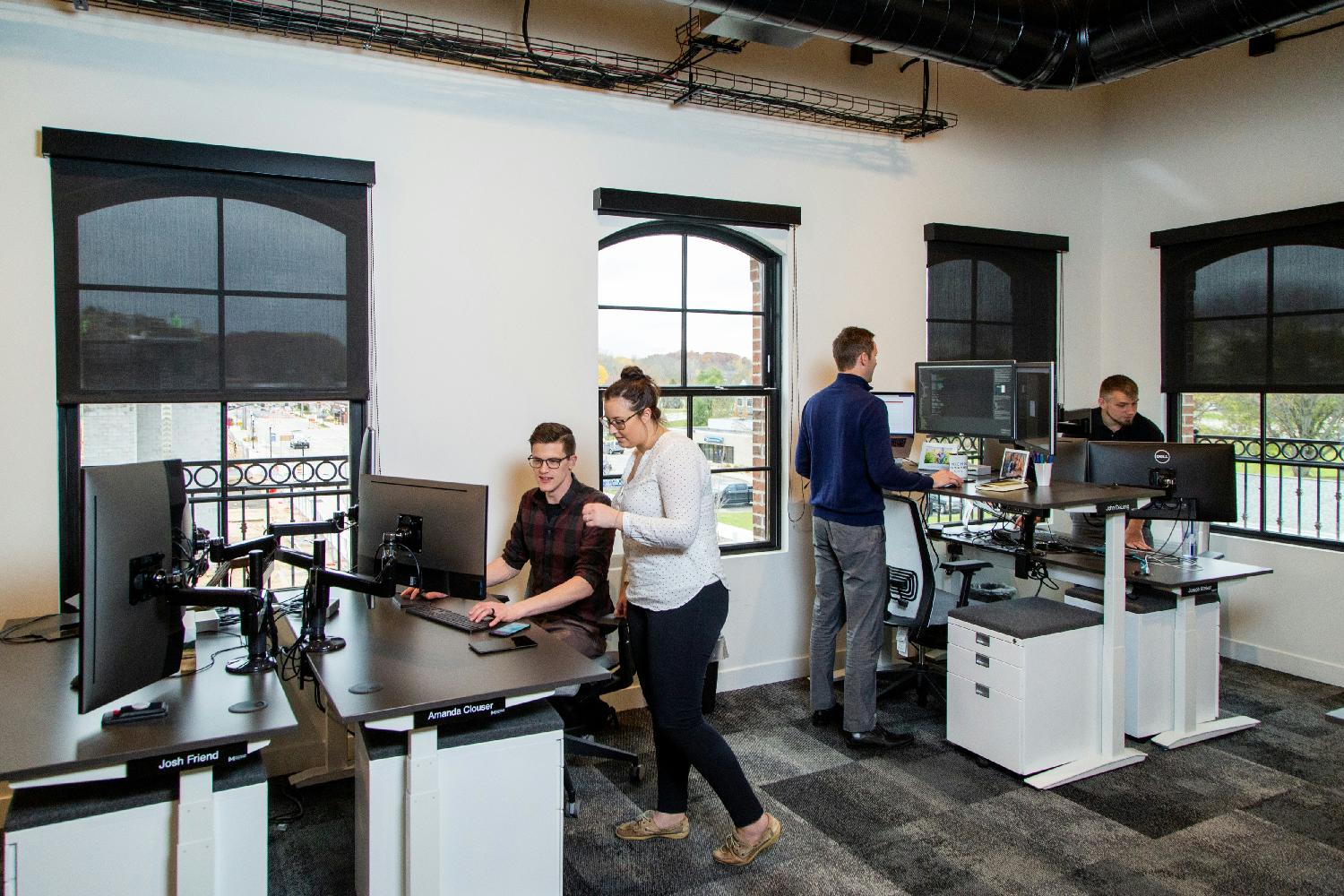 Team members working during a meeting.  Our new office has numerous spaces for team members to collaborate.